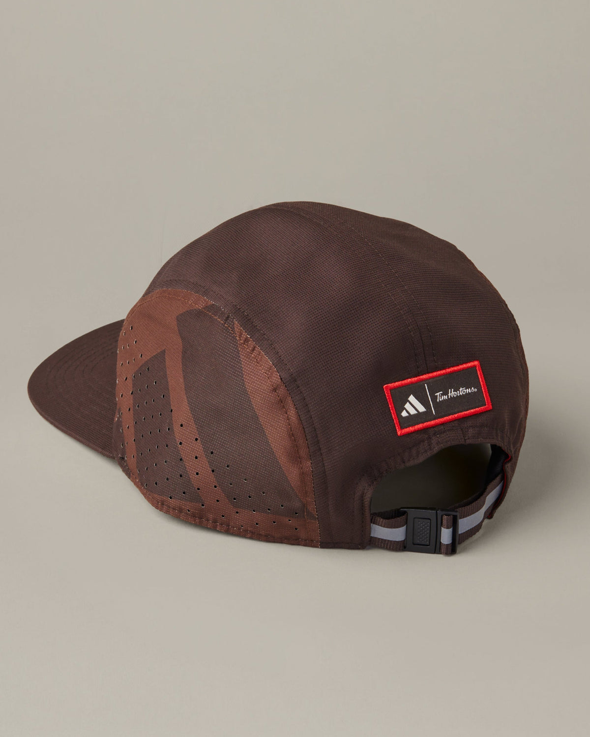 Espresso-brown adidas® trainer hat with perforated side panels and a cream Tims Run Club graphic on the front. - Image #3
