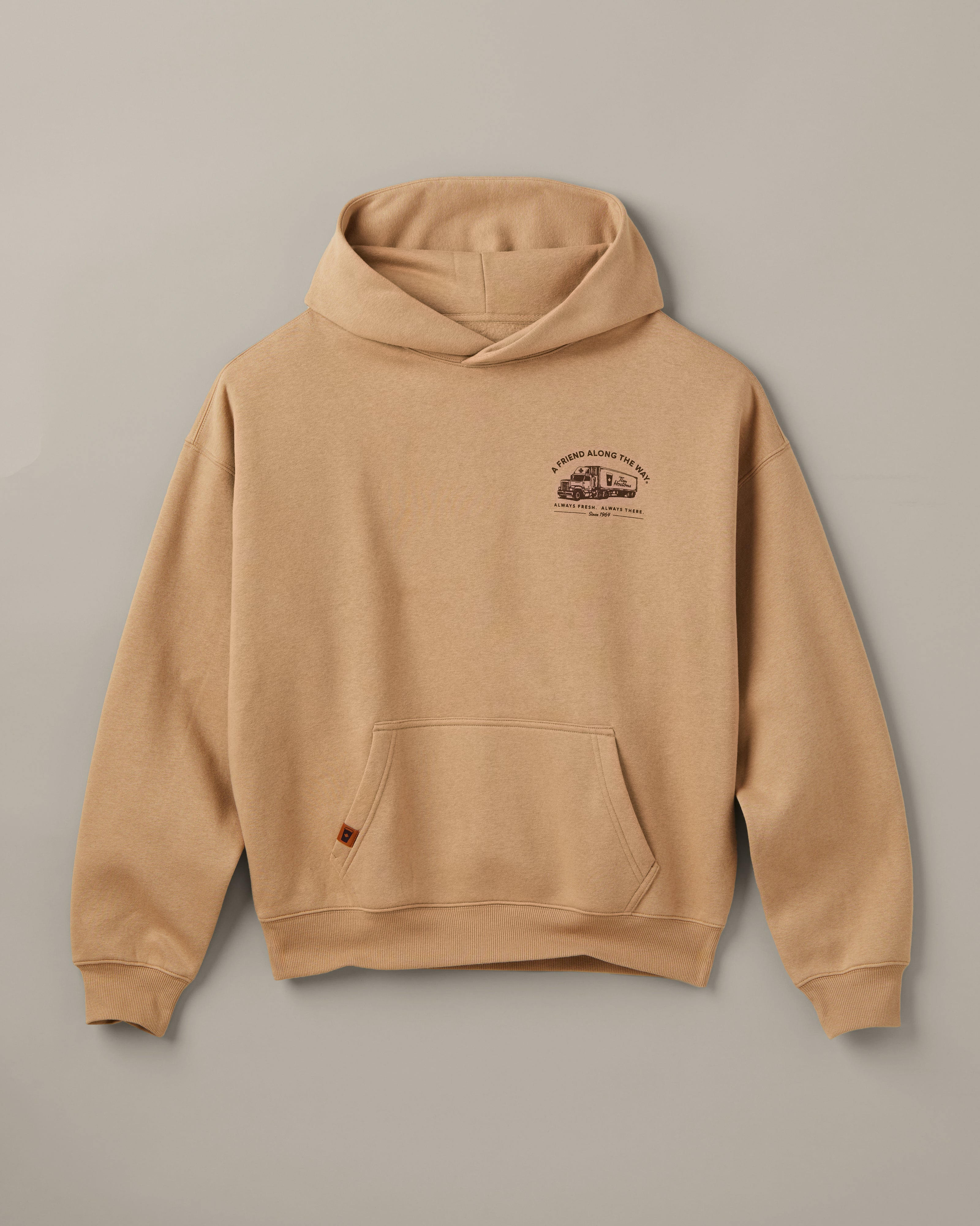 Beige Tim Hortons pullover hoodie with a kangaroo pocket and small A Friend Along the Way delivery truck graphic on the chest. | Chandail à capuchon Tim Hortons beige avec poche kangourou et petite illustration de camion de livraison « Un ami sur la route » sur la poitrine. - Image #4