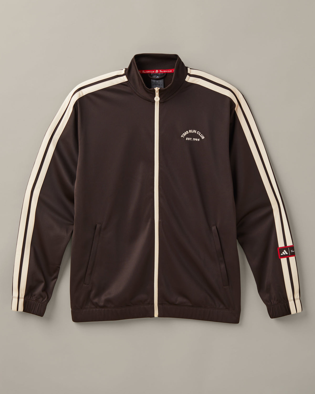 Men’s espresso-brown adidas® track top with a cream front zipper, cream 3-Stripes, and a Tims Run Club chest graphic. - Image #2