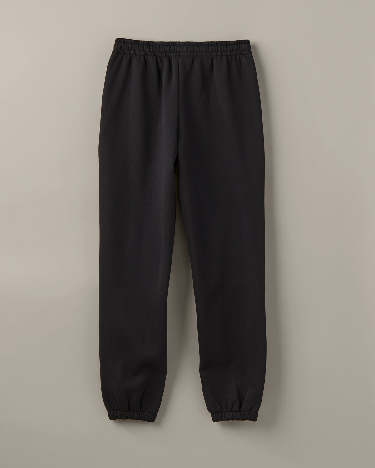 Black unisex joggers with a drawstring waist, cuffed ankles and a small graphic at the hip. | Pantalon en coton ouaté unisexe noir avec lacet de serrage à la taille, chevilles côtelées et petite image sur la hanche. - Image #3