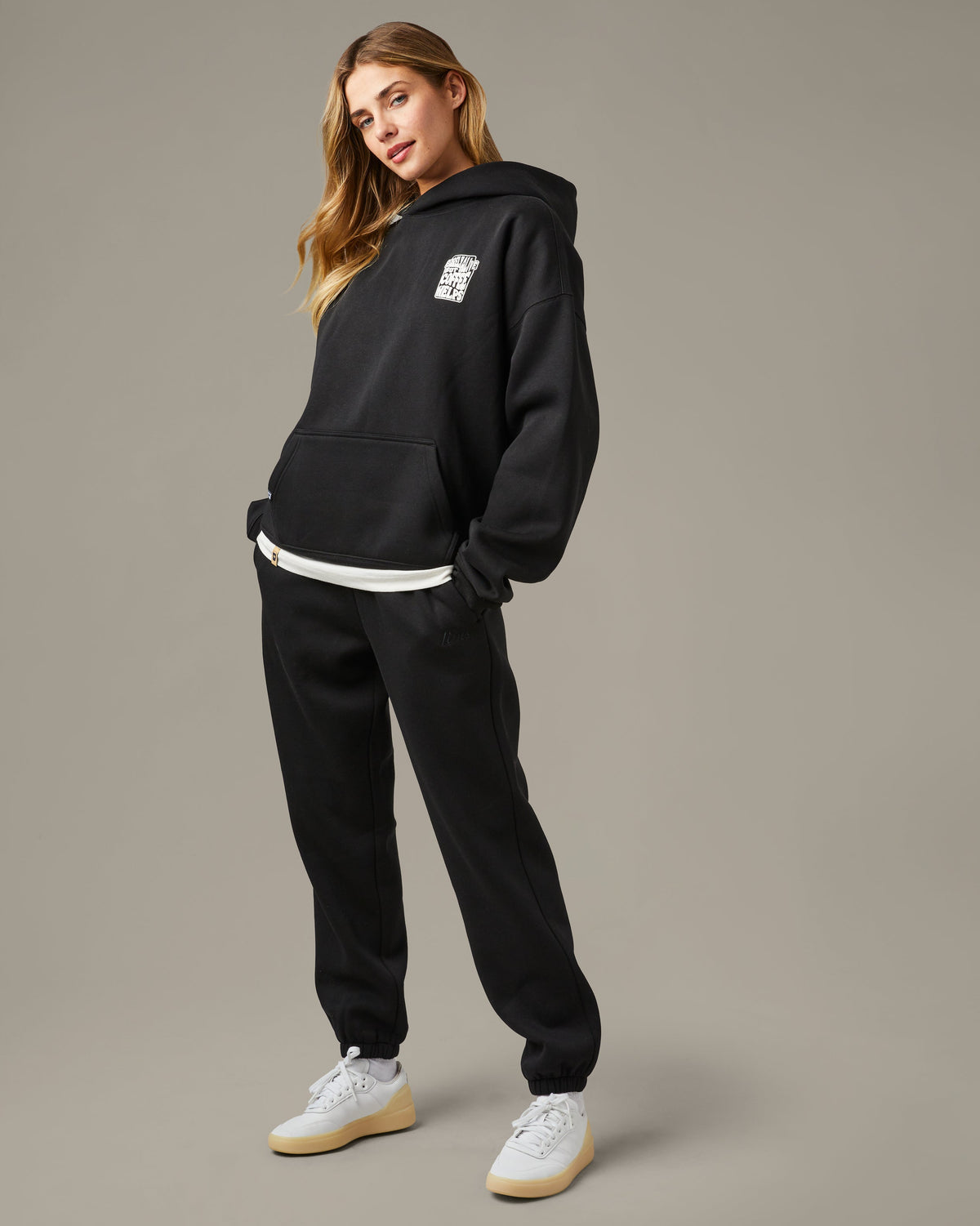 Black unisex pullover hoodie with a small white Barely Alive graphic on the chest. | Chandail à capuchon unisexe noir avec design « Barely Alive » sur le torse.