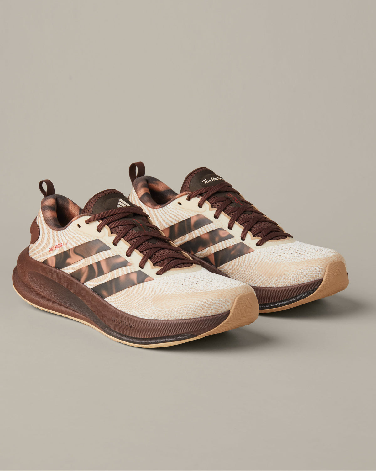 Men’s adidas® Supernova Ease running shoes in cream and coffee-brown shades with patterned 3-Stripes and Tim Hortons details.