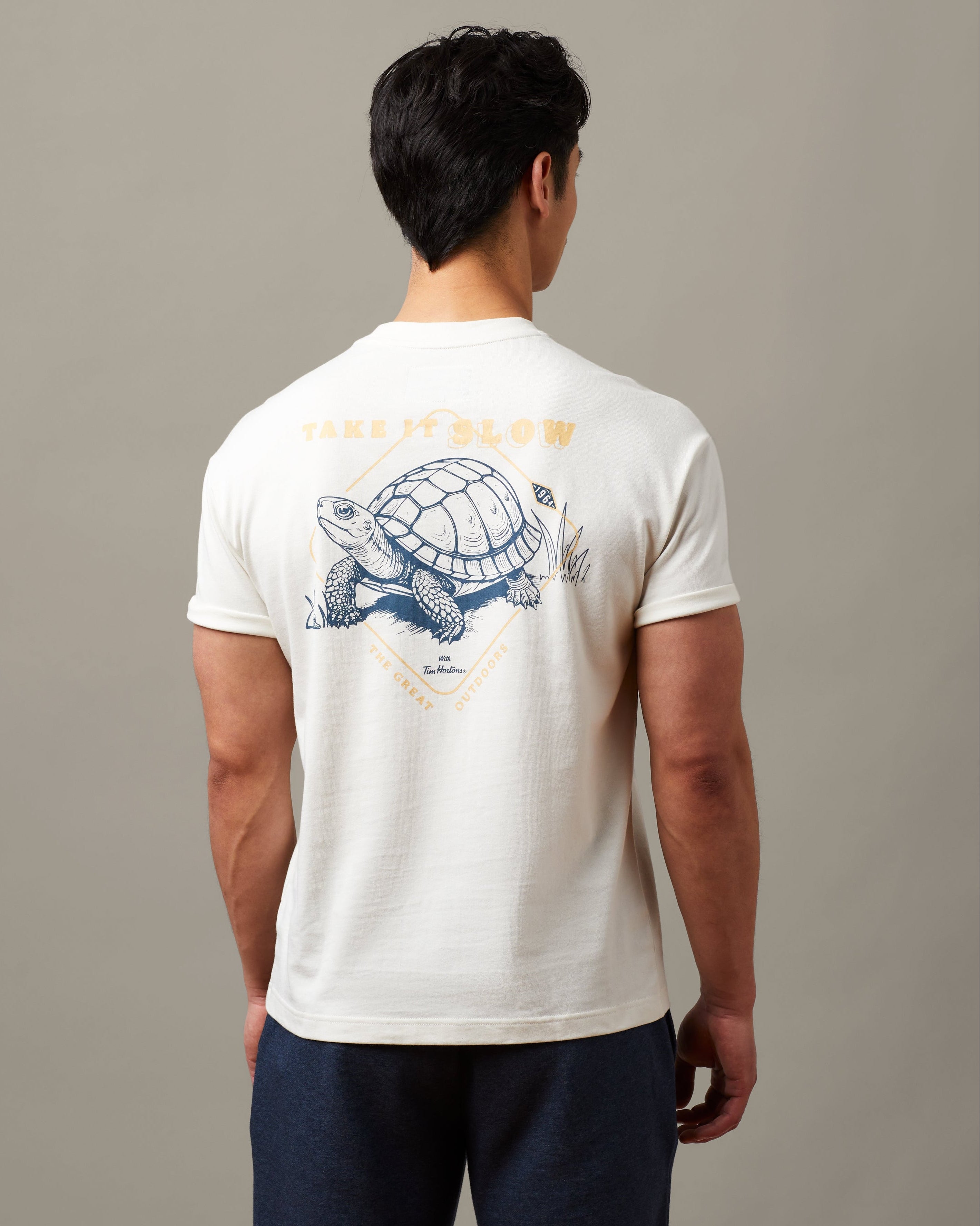 Natural unisex t-shirt featuring Take it Slow Tim Hortons graphic | T-shirt unisexe couleur naturelle « Take it Slow » de Tim Hortons.