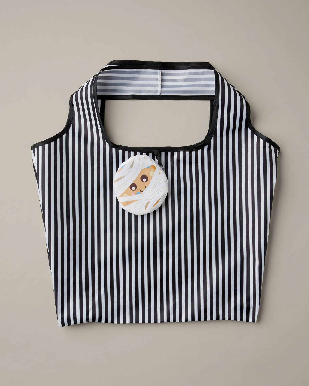 Black-and-white striped packable tote bag with a Timbits® Mummy storage pouch. | Sac réutilisable repliable rayé noir et blanc avec poche de rangement momie TimbitsMD. - Image #3