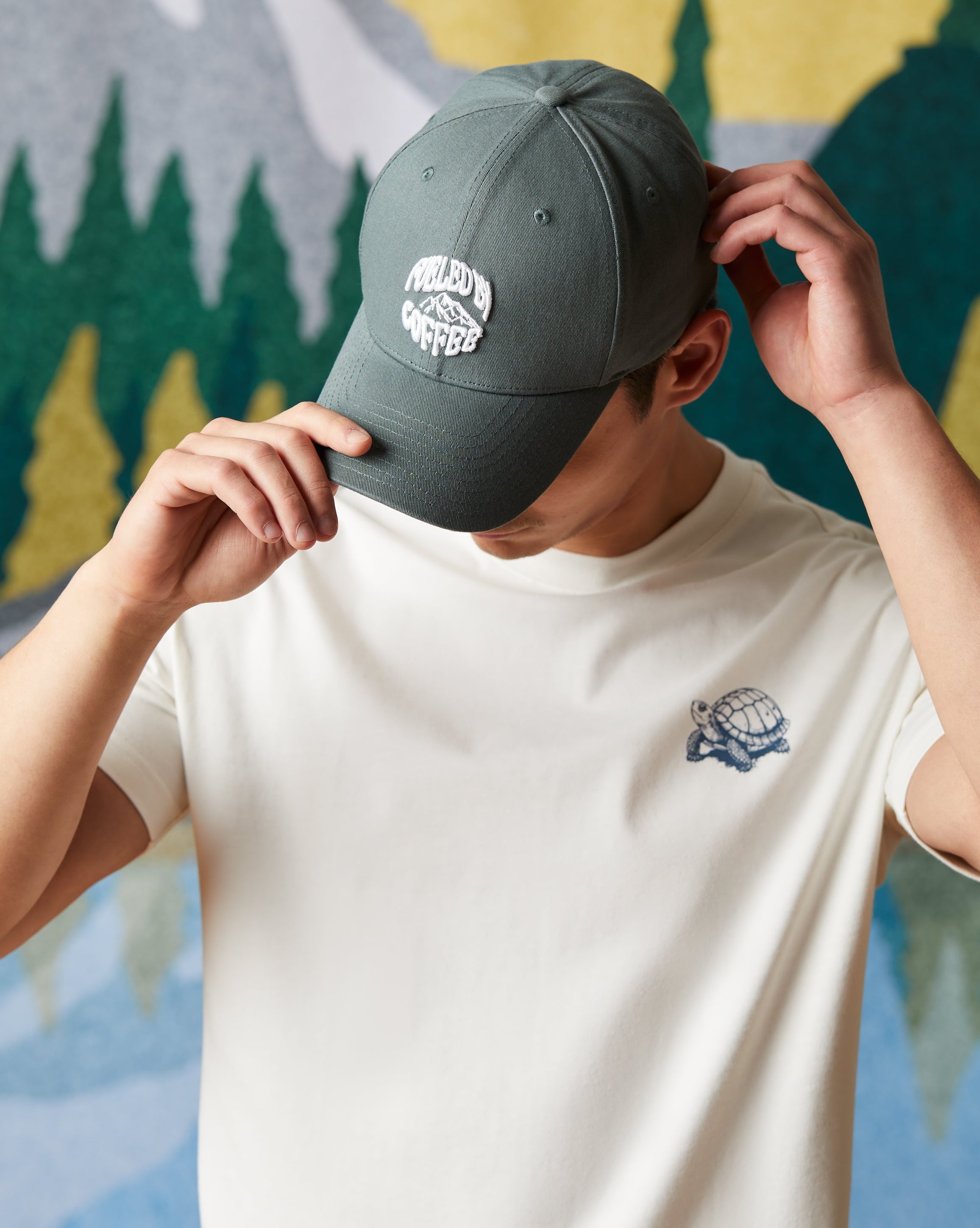 Forest green baseball hat featuring Fueled by Coffee logo on front panel | Casquette de baseball vert forêt avec logo « À vos marques, prêts, café! » à l’avant. - Image #1