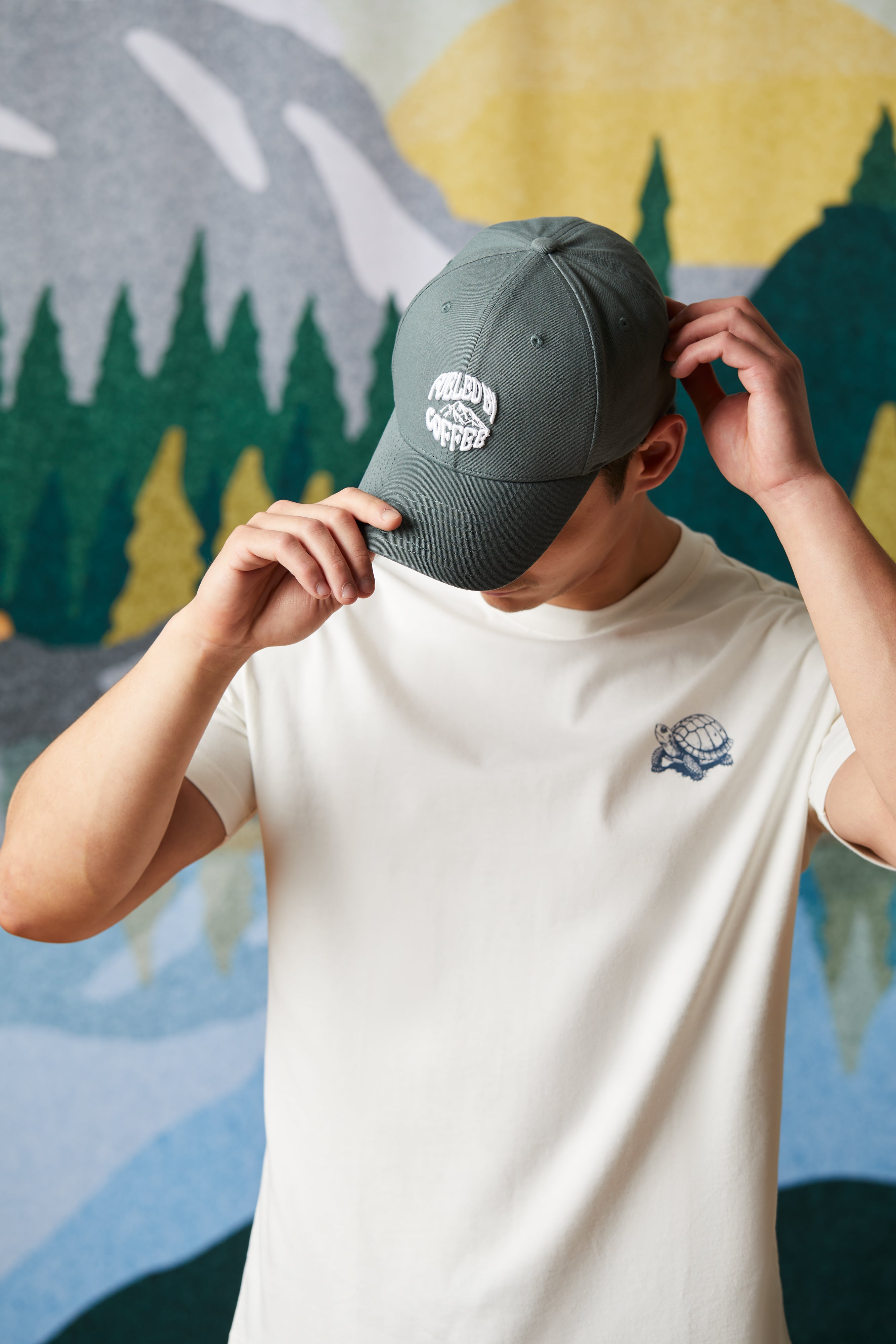 Forest green baseball hat featuring Fueled by Coffee logo on front panel | Casquette de baseball vert forêt avec logo « À vos marques, prêts, café! » à l’avant. - Image #1