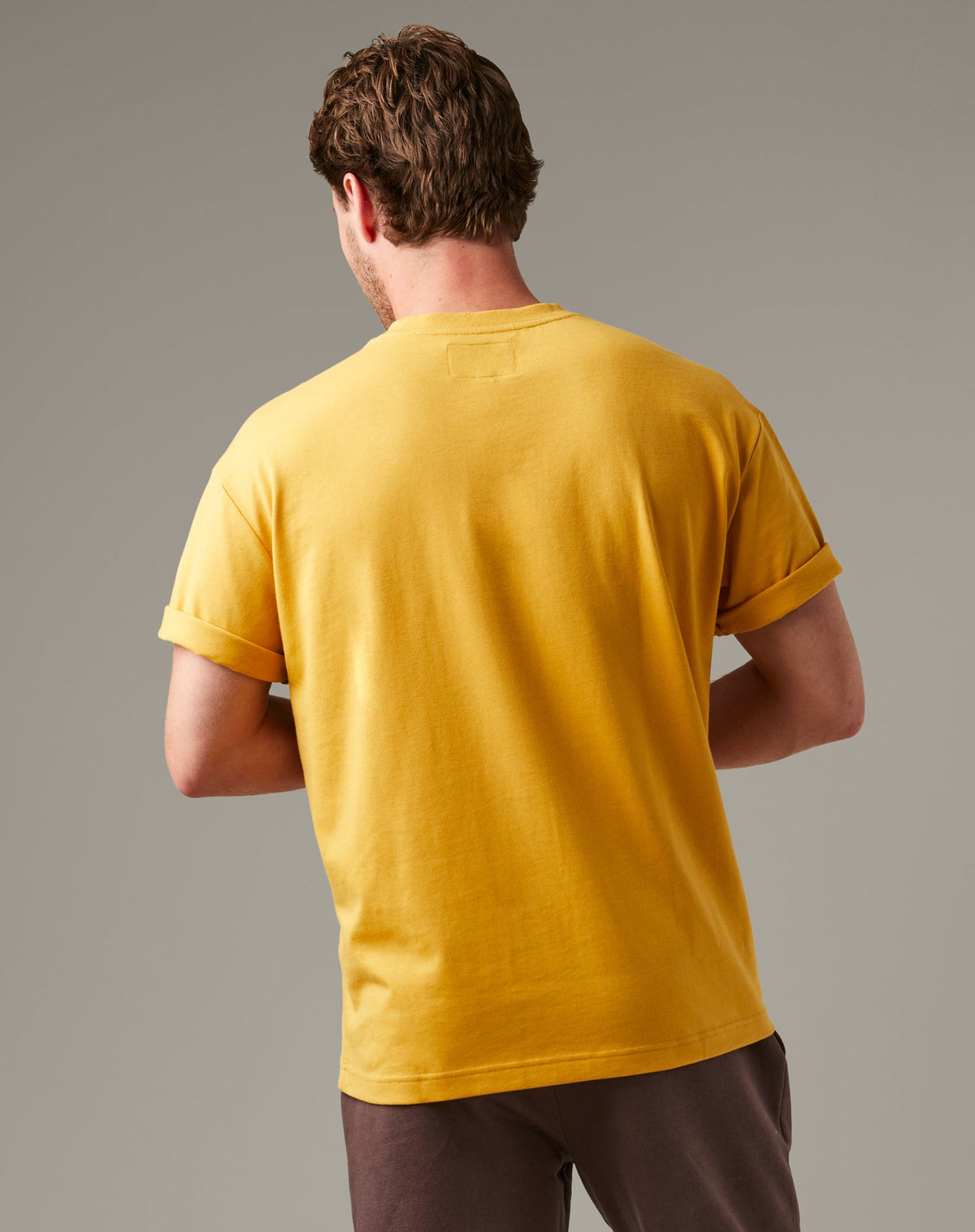 Ochre Tim Hortons crew-neck T-shirt with a small Pick Up Some Tims crane and coffee cup graphic on the chest. | T-shirt Tim Hortons ocre à encolure ronde avec une petite illustration de grue et de gobelet de café « Prendre son Tim » sur la poitrine. - Image #2