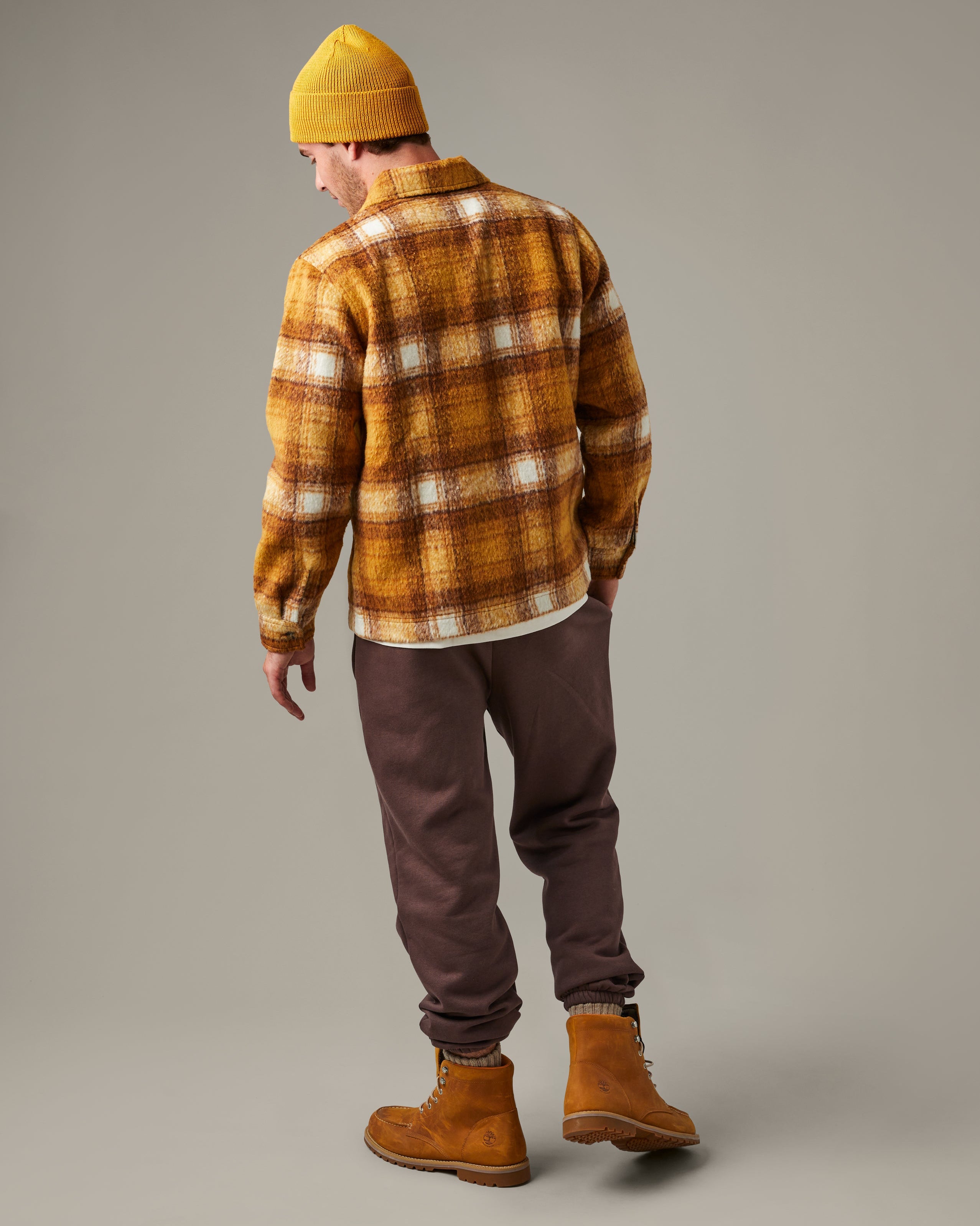 Yellow, brown, and cream plaid Tim Hortons shacket with a button front, two flap chest pockets, and a small logo patch. | Surchemise Tim Hortons à carreaux jaunes, bruns et crème, avec fermeture à bouton sur le devant, deux poches poitrine à rabat et un petit écusson à logo. - Image #2