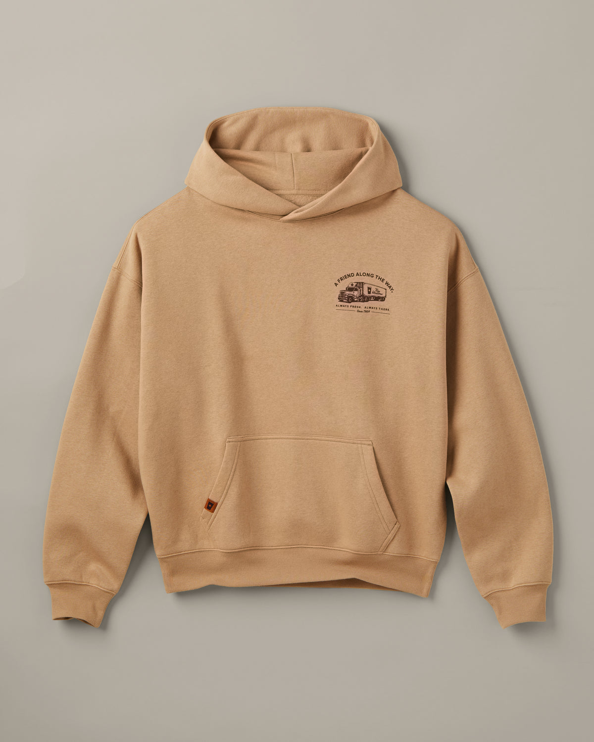 Beige Tim Hortons pullover hoodie with a kangaroo pocket and small A Friend Along the Way delivery truck graphic on the chest. | Chandail à capuchon Tim Hortons beige avec poche kangourou et petite illustration de camion de livraison « Un ami sur la route » sur la poitrine. - Image #4