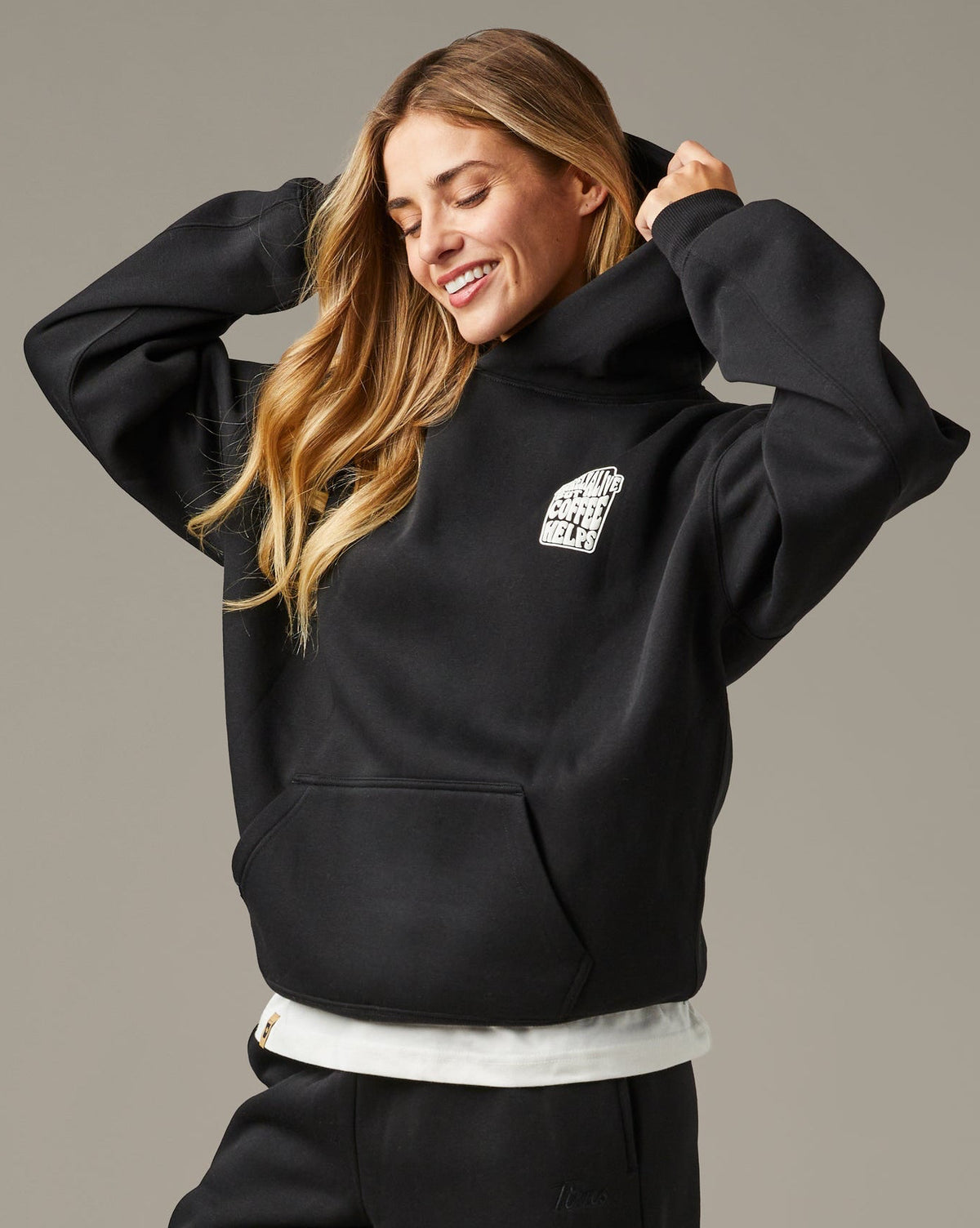 Black unisex pullover hoodie with a small white Barely Alive graphic on the chest. | Chandail à capuchon unisexe noir avec design « Barely Alive » sur le torse.