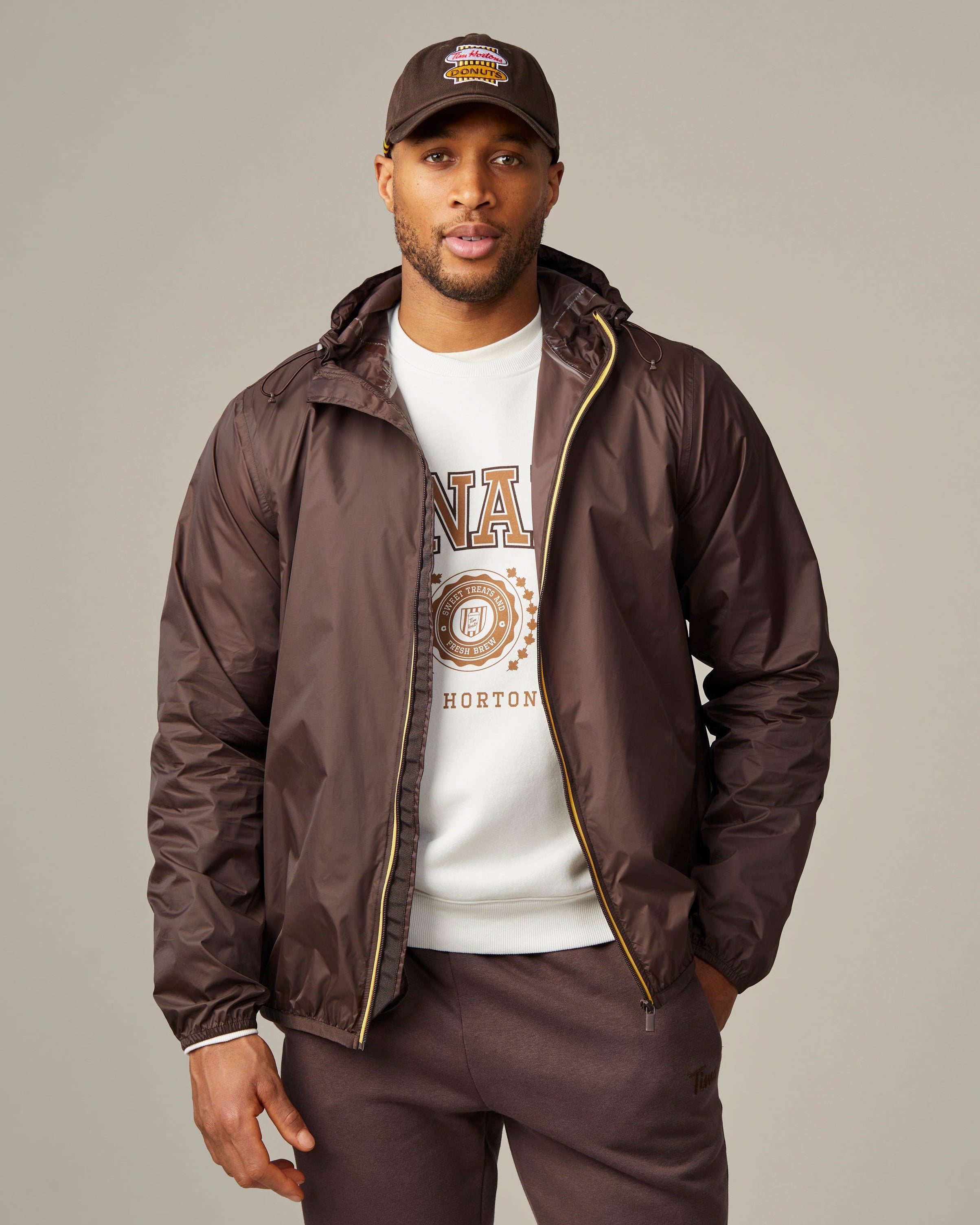 Espresso-coloured unisex packable jacket featuring retro Tim Hortons logo | Veste compressible unisexe espresso avec logo Tim Hortons rétro. - Image #1