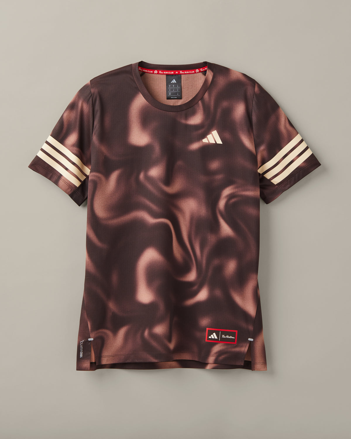 Espresso-brown adidas® CLIMACOOL T-shirt with cream sleeve stripes and a Tims Run Club coffee-and-donut graphic. - Image #1