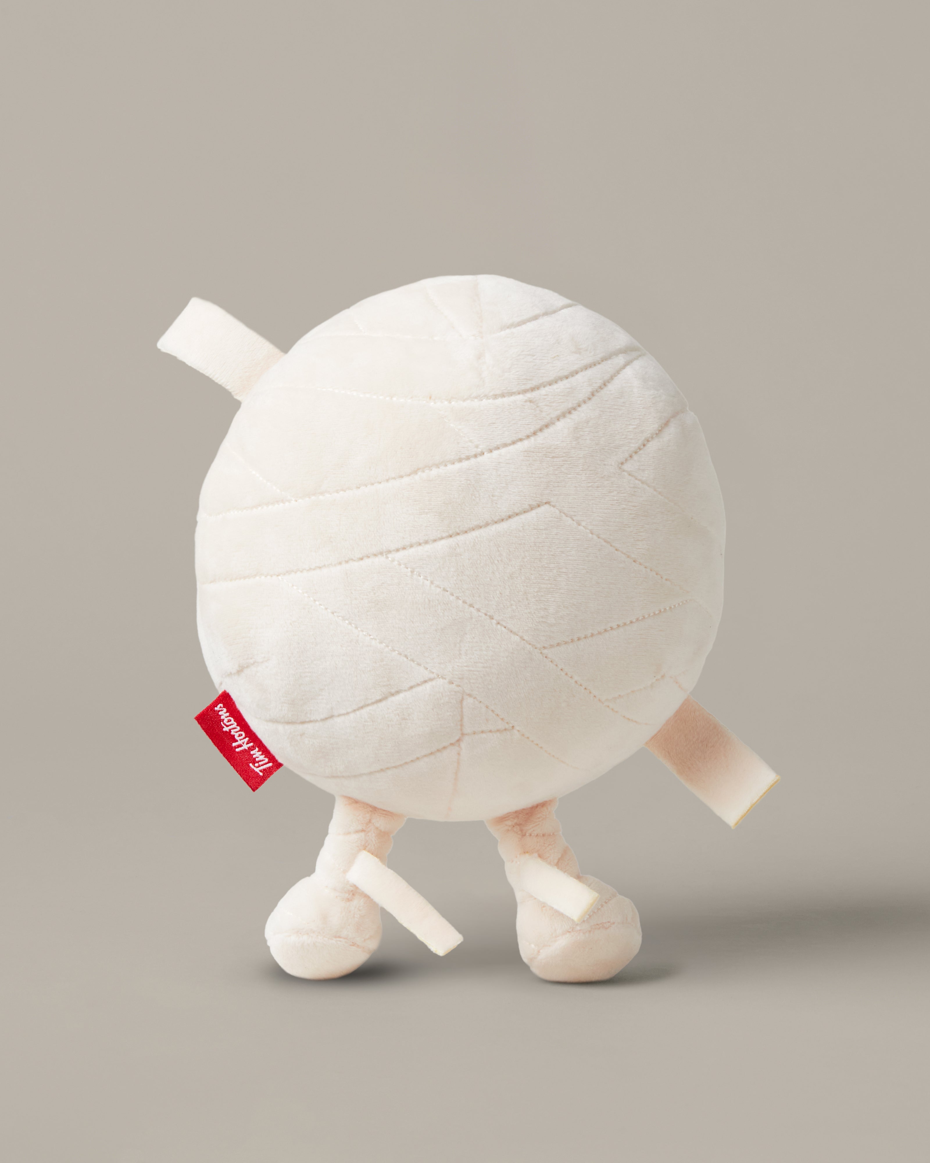 Timbits® Mummy plush with white wrapping, an embroidered face and black-and-white striped legs. | Peluche momie TimbitsMD avec bandelettes blanches, visage brodé et jambes rayées noir et blanc. - Image #2