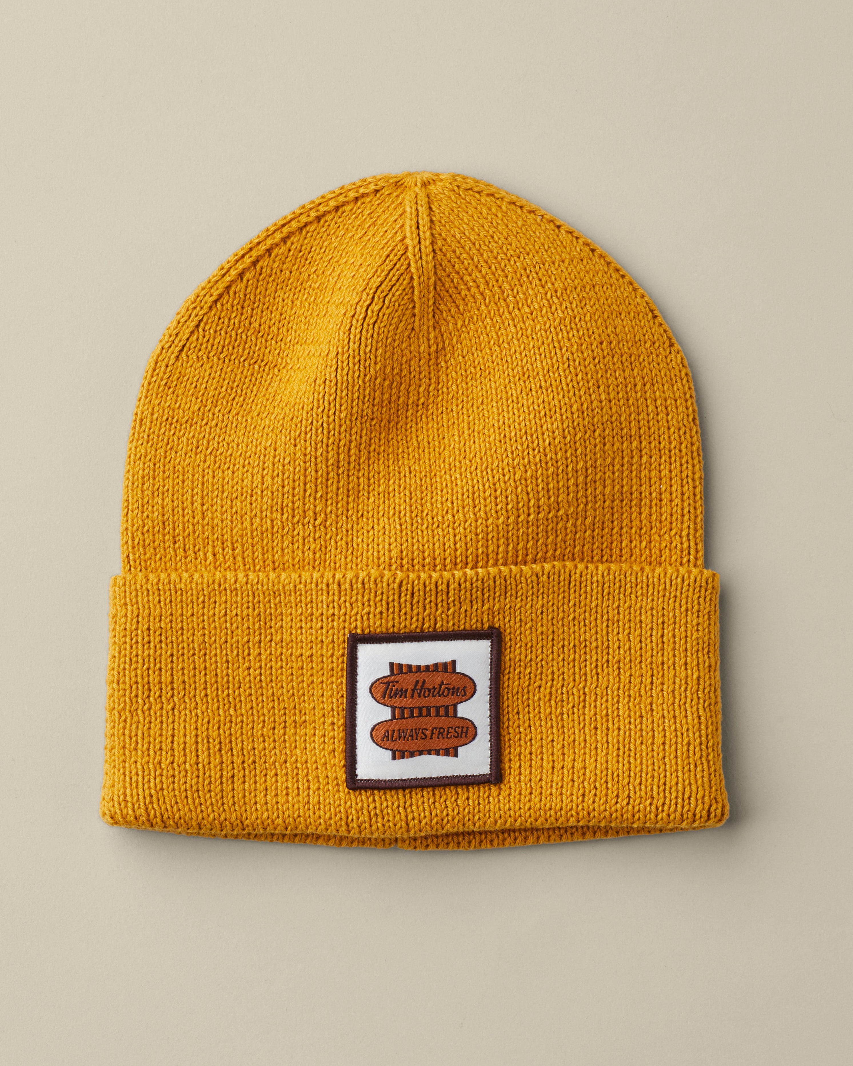Mustard yellow rib-knit Tim Hortons toque with a folded cuff and square Always Fresh logo patch. | Tuque Tim Hortons jaune moutarde en tricot côtelé, avec revers et écusson carré au logo Toujours frais. - Image #2